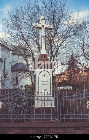 LAZISKA GORNE, POLOGNE - 12 mars 2021 : Croix à l'église notre-Dame, Reine du Saint Rosaire à Laziska Gorne, vue de derrière une clôture décorative Banque D'Images