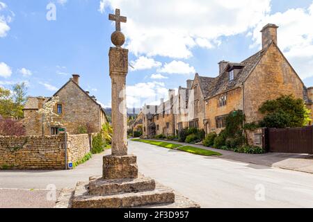 La vieille croix et cadran solaire dans le village Cotswold de Stanton, Gloucestershire Royaume-Uni Banque D'Images