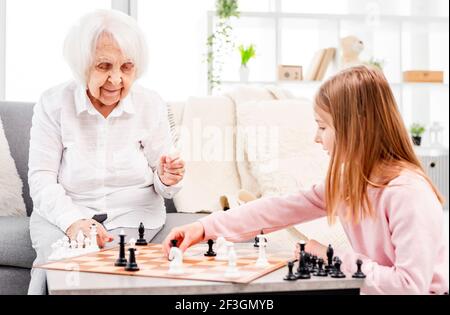 Fille jouant aux échecs avec grand-mère
