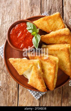 Mozzarella dans Carrozza sandwichs italiens frits avec sauce dans l'assiette sur la table. Vue verticale du dessus Banque D'Images