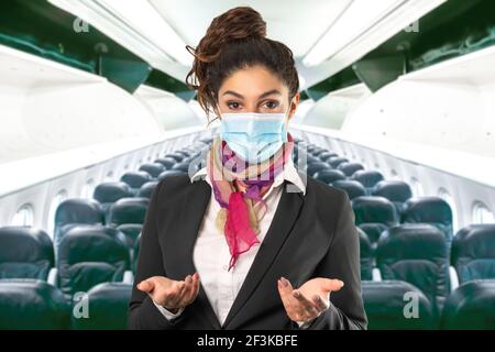 un beau gardien de vol avec masque chirurgical, foulard multicolore et veste noire. Sujet sur un arrière-plan flou. Photo parfaite pour les femmes au travail, Banque D'Images