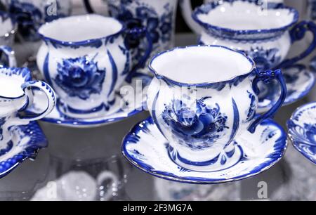 Porcelain cups and saucers made in Russian Gzhel style. Stock Photo