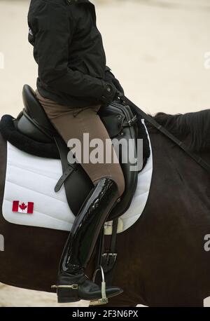 Cavalier de dressage équestre dans le siège de dressage approprié montrant le grand noir bottes de dressage beige jodhpurs anglais cuir dressage selle blanc selle bloc Banque D'Images