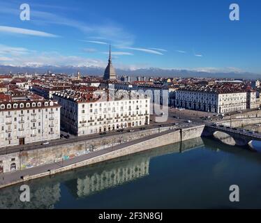 Vue aérienne du centre-ville de Turin, en Italie, par temps ensoleillé, avec Mole Antonelliana et les Alpes en arrière-plan. Banque D'Images