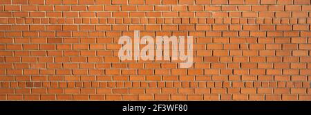 Un gros plan d'un mur de briques rouges. Photo de haute qualité. Banque D'Images