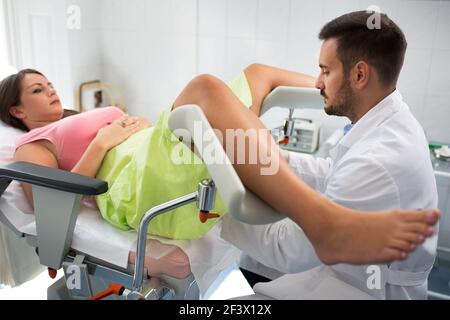 Belle jeune femme couché dans la clinique de gynécologie faisant l'examen Banque D'Images