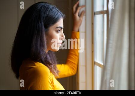 Portrait en gros plan de la femme persane à la maison tout en regardant par la fenêtre. Femme persane en regardant par la fenêtre Banque D'Images