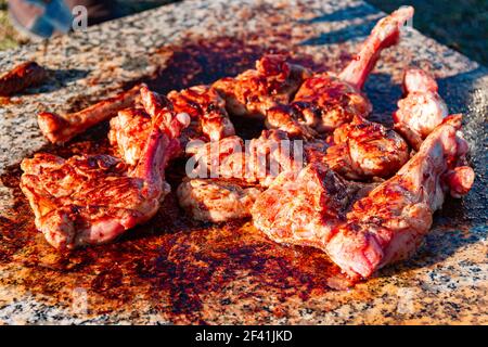 la viande de jeune agneau sur l'os est frite sur une dalle de marbre. Pique-nique dans la nature. Délicieux rôti d'agneau juteux. Cuisine dans la nature. Attention sélective. Banque D'Images