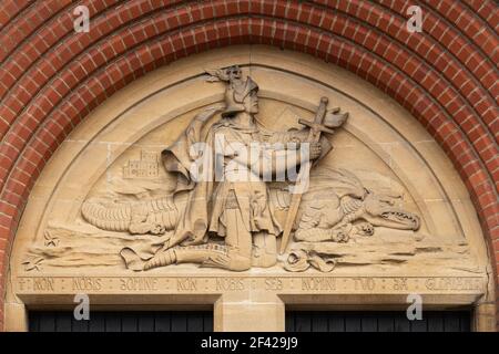 Soulagement ou frise de St George en balançant le dragon au-dessus de la porte de l'église de la cathédrale de St Michael et St George à Aldershot, Hampshire, Royaume-Uni Banque D'Images