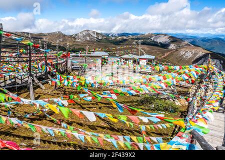 Beaucoup de drapeaux bouddhistes tibétains de prière agitant avec le vent à Sommet de la montagne Shika à Shangri-la Yunnan en Chine Banque D'Images