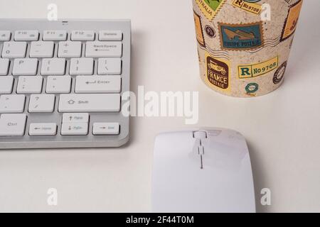 Vue du clavier et de la souris d'un ordinateur moderne avec une tasse de café. Banque D'Images