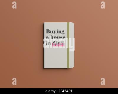 Une vue de dessus d'un livre avec "achat d'une maison en 2021' écrit sur une couverture sur fond marron Banque D'Images