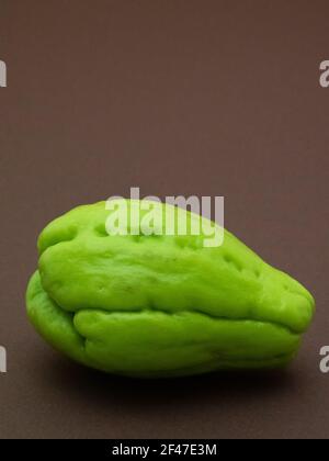 Fruit de chayote isolé sur fond marron Banque D'Images