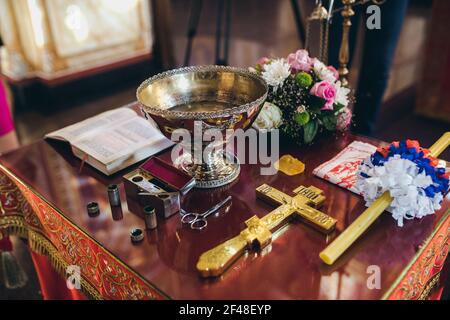 Les accessoires de baptême pour le rituel sacré arrangé sur le autel de l'église Banque D'Images