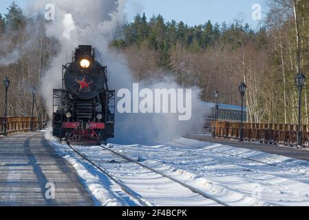 RUSKEALA, RUSSIE - 10 MARS 2021 : le train rétro touristique 'Ruskeala Express' arrive à la gare de Ruskeala l'après-midi de mars Banque D'Images