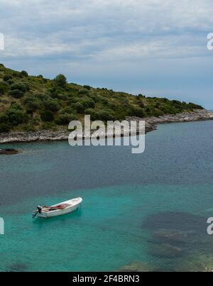 Croatie, île de Dugi otok, 15 juillet 2019: Belle photo verticale, solitaire, blanc, bateau en bois sur la mer. Concept d'été avec mer claire. Banque D'Images