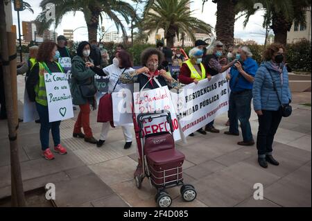 Malaga, Espagne. 20 mars 2021. Une femme portant un masque facial ajuste son écriteau dans la rue lorsqu'elle prend part à une protestation contre les coupures dans le système public de santé. (Photo de Jesus Merida/SOPA Images/Sipa USA) Credit: SIPA USA/Alay Live News Banque D'Images