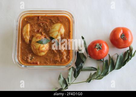 Curry d'œufs. Œufs durs dans une sauce à base de noix de cajou et de tomate. Prise de vue sur fond blanc Banque D'Images