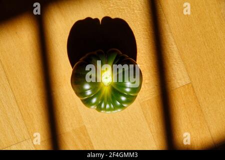 Détail d'une délicieuse tomate verte de marmande illuminée par lumière du soleil Banque D'Images