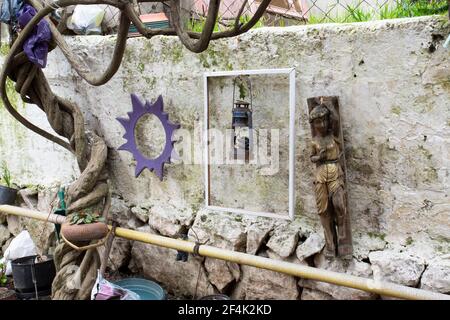 Différents et anciens objets alignés devant le Mur en pierre blanche et tronc de l'arbre BlackBerry Banque D'Images