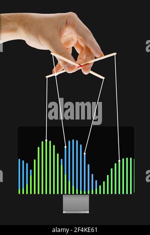 Un homme d'affaires qui maintient la croissance de l'économie, manipule des graphiques comme une marionnette Banque D'Images