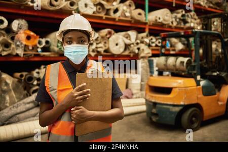 Ouvrier d'entrepôt africain portant un masque facial Banque D'Images