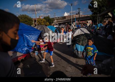 Tijuana, Mexique. 22 mars 2021. Les enfants jouent à El Chaparral plaza à Tijuana, au Mexique, le dimanche 21 mars 2021. Des centaines de demandeurs d'asile ont installé des tentes près du port d'entrée dans l'espoir de pouvoir demander l'asile aux États-Unis. Biden s'est engagé à prendre de nouvelles mesures pour faire face à l'afflux de migrants à la frontière depuis son arrivée au pouvoir. Photo par Ariana Drehsler/UPI crédit: UPI/Alay Live News Banque D'Images