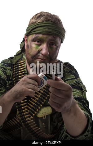 Homme acteur sous la forme d'un phoque à fourrure américain posant avec une mitrailleuse dans ses mains sur un fond blanc. Forces spéciales au Vietnam, années 1970. Banque D'Images