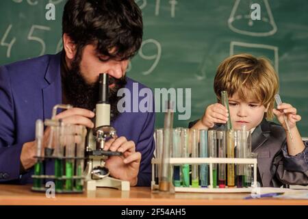 Professeur et garçon en laboratoire chimique. Étudier la chimie et la biologie. Exemple personnel et inspiration. Étudier est intéressant. Études éducatives Banque D'Images