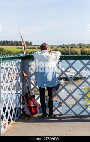 Woodbridge, Suffolk, Royaume-Uni septembre 20 2020: Une femme de 20 quelque chose de relaxant et posant avec sa guitare acoustique Banque D'Images