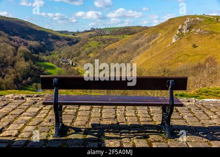 Banc en bois au soleil du début du printemps à Monsal Head un point de vue populaire dans le parc national de Peak District Derbyshire Angleterre Royaume-Uni. Banque D'Images