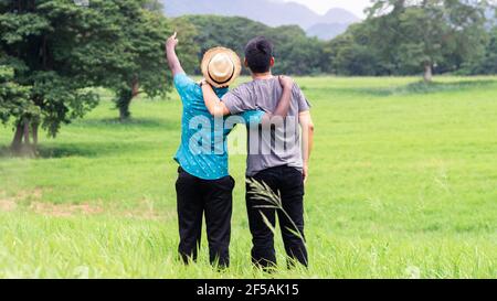 Deux hommes de voyageurs embrassant et regardant la vue de la montagne . Concept de meilleurs amis Banque D'Images