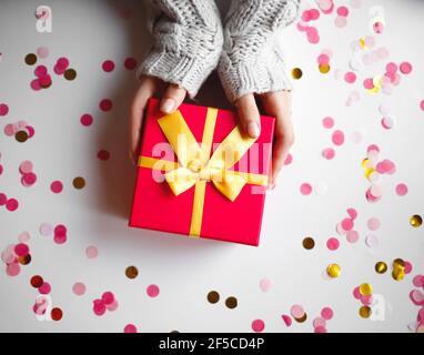 les mains des femmes avec une belle manucure tiennent une boîte cadeau. Banque D'Images