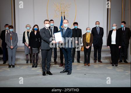 Paris, France. 26 mars 2021. Le président français Emmanuel Macron détient conjointement un document le long de l'historien Vincent Duclert, qui dirige la commission rwandaise et son équipe (derrière) à la salle des Fete à l'Elysée Palace à Paris, en France, le 26 mars 2021. Photo par Eric Tschaen/Pool/ABACAPRESS.COM crédit: Abaca Press/Alay Live News Banque D'Images