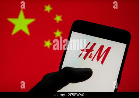 Sur cette photo, le logo de la société suédoise de design de vêtements Hennes & Mauritz, H&M, est visible sur un appareil mobile Android avec le drapeau de la République populaire de Chine en arrière-plan. Banque D'Images