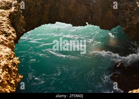 Spectaculaire Mermaid Caves avec lumière du soleil traversant le trou dans les roches volcaniques dans la piscine d'eau dans la grotte, à Nanakuli Beach Park, Oahu, Hawaii, Etats-Unis Banque D'Images