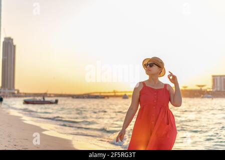 vue romantique d'une femme sur la plage avec belle vue sur le coucher du soleil Banque D'Images