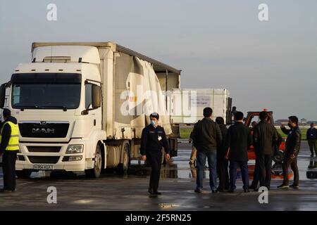 Tachkent, Ouzbékistan. 27 mars 2021. Les travailleurs transfèrent les vaccins COVID-19 à l'aéroport international de Tachkent, à Tachkent (Ouzbékistan), le 27 mars 2021. Le premier lot de vaccins chinois contre le coronavirus est arrivé samedi en Ouzbékistan. Credit: Zafar Khalilov/Xinhua/Alamy Live News Banque D'Images