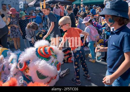 (210328) -- WELLINGTON, le 28 mars 2021 (Xinhua) -- les enfants jouent pendant le festival d'art et de musique de plein air CubaDupa à Wellington, Nouvelle-Zélande, le 27 mars 2021. Le quartier de Cuba Street dans la capitale de la Nouvelle-Zélande est venu en vie au cours du week-end, tandis que les danses de lion chinois et la musique traditionnelle chinoise ornaient le plus grand festival d'art et de musique de plein air de Nouvelle-Zélande CubaDupa. L'événement a été forcé de pivoter en 2019 vers une version hors-rue en raison des tragédies de la mosquée de Christchurch, et en 2020, il a été impossible de procéder en raison des restrictions de verrouillage de la COVID-19. Cependant, le CubaDupa 2021 est revenu avec Banque D'Images
