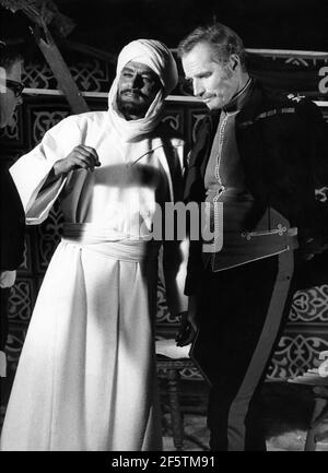 LAURENCE OLIVIER en costume comme le Mahdi et CHARLTON HESTON comme le général Charles ''Chinois' Gordon sur le set Candid pendant le tournage de KHARTOUM 1966 réalisateur BASIL DEARDEN écrivain Robert Ardrey Julian Blaustein Productions Ltd. / United Artists Banque D'Images