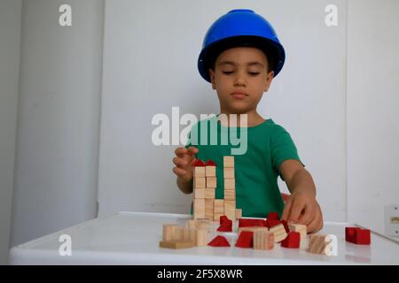 salvador, bahia, brésil - 25 janvier 2021 : un enfant jouant avec un bloc de bois de construction pour enfants dans la ville de Salvador. *** Légende locale *** Banque D'Images