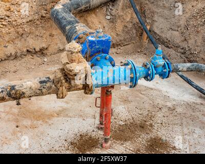 Réparation de la principale branche d'alimentation en eau potable dans les banlieues. Processus de réparation du pipeline d'approvisionnement en eau souterraine Banque D'Images