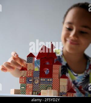 salvador, bahia, brésil - 24 janvier 2021 : un enfant jouant avec un bloc de bois de construction pour enfants dans la ville de Salvador. Banque D'Images