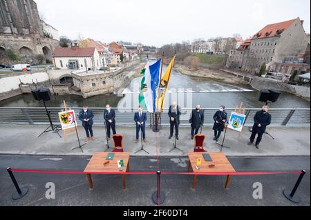 29 mars 2021, Saxe, Görlitz: Octavian Ursu (CDU, 2e de gauche), Maire de Görlitz, Michael Kretschmer (CDU, 3e de gauche), Premier ministre de Saxe, Cezary Przybylski (4e à partir de la gauche), maréchal de la Voïvodie Basse-Silésie polonaise, Et Rafal Groniz (3e from.r.), maire de Zgorzelec, se tiennent sur le pont de la vieille ville, à la frontière germano-polonaise, à l'occasion de la signature d'une lettre de soutien à l'UE pour un approvisionnement en chaleur neutre pour la ville frontalière. Photo: Sebastian Kahnert/dpa-Zentralbild/dpa Banque D'Images