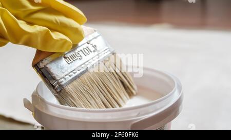 Appliquer de la colle blanche sur le tissu de coton à l'aide d'une brosse Banque D'Images