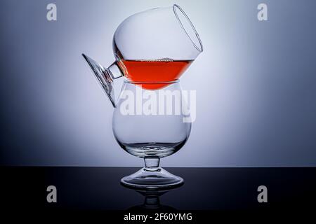 Verres de Cognac avec une boisson sur fond sombre. Plats pour cognac et autres boissons. Banque D'Images