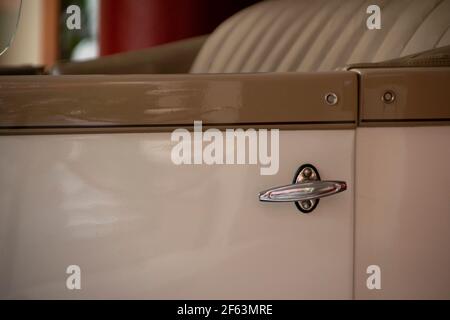 Poignée de porte d'une vieille voiture. Couleur blanc et marron. Banque D'Images