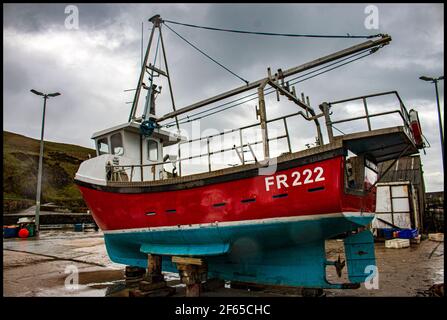 Bateau de pêche sur la jetée pour une peinture et réparations Banque D'Images