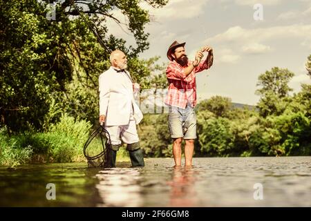 Belle journée pour la pêche. Père à la retraite et fils mûrs avec barbe. Aventures de pêche à la mouche. Passe-temps de l'homme d'affaires. Pêche à la retraite. Pêcheurs heureux dans Banque D'Images