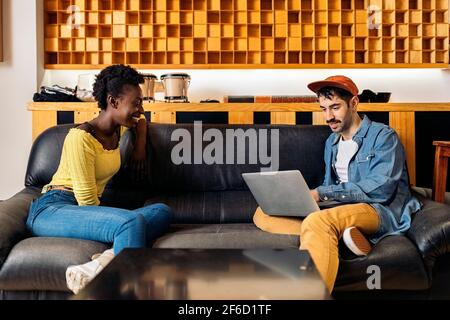 Photo du producteur de musique et du chanteur noir parlant dans le studio de musique et utilisant un ordinateur portable. Banque D'Images